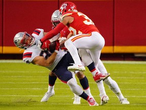 New England Patriots running back Rex Burkhead (34) is tackled by Kansas City Chiefs safety Tyrann Mathieu (32) Monday at Arrowhead Stadium.