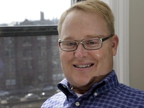 In this April 15, 2015, file photo, former Boston University hockey player Travis Roy poses in his apartment in downtown Boston.