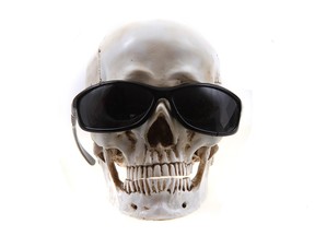 Skull with sunglasses isolated on the white background.