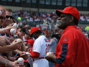 Hall-of-Famer Bob Gibson of the St Louis Cardinals signs autographs for fans before taking on the Washington Nationals at Roger Dean Stadium on March 10, 2010 in Jupiter, Florida.