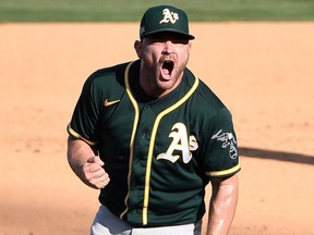 Oakland Athletics relief pitcher Liam Hendriks celebrates after the Athletics defeated the Houston Astros in Game 3 of the 2020 ALDS at Dodger Stadium.