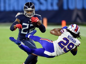 Tennessee Titans running back Derrick Henry (22) tosses Buffalo Bills cornerback Josh Norman (29) to the field at Nissan Stadium on Tuesday, Oct. 13, 2020 in Nashville, Tenn.