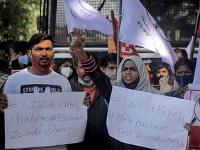 All India Progressive Women's Association (AIPWA) activists hold placards and shout slogans during a demonstration against the recent death of a 19-year-old Dalit woman, who was allegedly gang-raped by four in Bangalore on October 1, 2020.