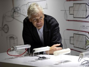 In this file photo taken on October 11, 2018, British industrial design engineer and founder of the Dyson company, James Dyson, poses with products during a photo session at a hotel in Paris.