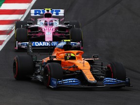 Lando Norris, driving the McLaren F1 Team MCL35 Renault leads Lance Stroll driving the Racing Point RP20 Mercedes on track during the F1 Grand Prix of Portugal at Autodromo Internacional do Algarve on October 25, 2020 in Portimao, Portugal.