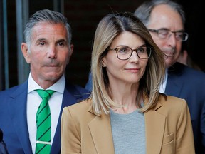 Lori Loughlin and her husband, fashion designer Mossimo Giannulli, leave the federal courthouse in Boston  April 3, 2019.