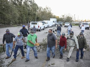 Workers clear debris from Hurricane Zeta at St. Bernard Middle School on October 29, 2020 in St Bernard, Louisiana.
