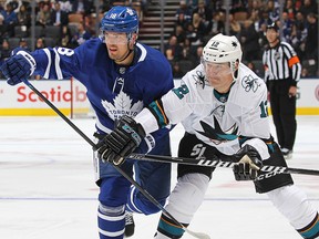 Patrick Marleau of the San Jose Sharks battles against Andreas Johnsson of the Toronto Maple Leafs during an NHL game at Scotiabank Arena on October 25, 2019 in Toronto.