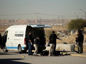 Forensic technicians are preparing to remove the body of a person as unknown assailants left bodies of four people, according to local media, in Ciudad Juarez, Mexico October 30, 2020.
