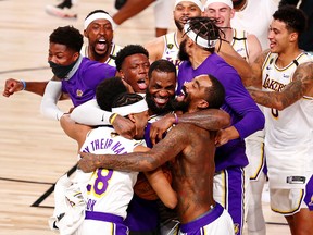 The Los Angeles Lakers celebrate their win over the Miami Heat after Game 6 of the NBA Finals at AdventHealth Arena.