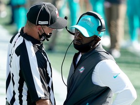 Miami Dolphins head coach Brian Flores talks to an official as they take on the New England Patriots at Gillette Stadium.