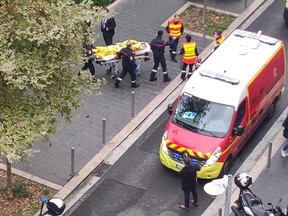 Emergency responders transport a wounded person on a gurney after an attack at a church in Nice, France, October 29, 2020 in this still image taken from a video obtained by REUTERS.