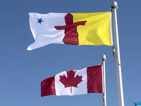 The Nuvanut flag and the Canadian flag are seen Saturday, April 25, 2015 in Iqaluit, Nunavut.