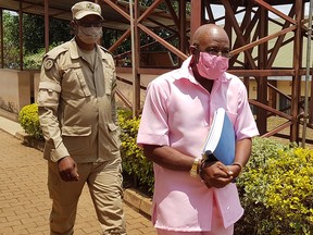 Paul Rusesabagina, portrayed as a hero in a Hollywood movie about Rwanda's 1994 genocide, is escorted in handcuffs from the courtroom in Kigali, Rwanda September 25, 2020.