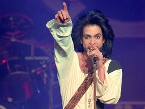 In this file photo taken on June 16, 1990 Prince performs on stage during his concert at the Parc des Princes stadium in Paris.