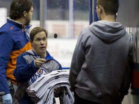 Edmonton locker room attendant Joey Moss cleans up the bench after an Edmonton Oilers practice held at Rexall Place on Monday December 28, 2015.