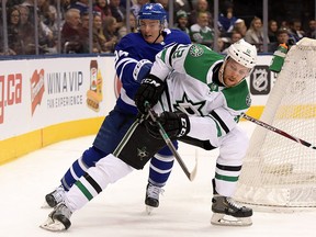 Dallas Stars forward Radek Faksa (12) battles for the puck with  Toronto Maple Leafs defenceman Tyson Barrie (94) at Scotiabank Arena.