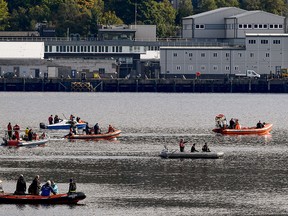 Boats are seen attempting to herd Northern Bottlenose whales from the Gare Loch into the open sea ahead of a military exercise starting in the region on October 1, 2020.