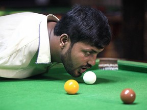 Muhammad Ikram, 32, who was born without arms, plays snooker with his chin at a local club in Samundri, Pakistan, October 20, 2020. Muhammad Ikram, 32, who was born without arms, plays snooker with his chin at a local club in Samundri, Pakistan, October 20, 2020. Picture taken October 20, 2020. REUTERS/Mohsin Raza ORG XMIT: HFS-GGGAS108