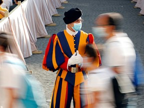 A Swiss Guard wearing a protective face mask patrols ahead of Pope Francis' weekly general audience at the San Damaso courtyard, at the Vatican, September 9, 2020