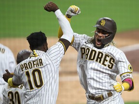 Jurickson Profar congratulates teammate Fernando Tatis Jr. of the San Diego Padres after his two-run home run during Game 2 of the National League Wild Card Series against the St. Louis Cardinals at PETCO Park on October 1, 2020 in San Diego.