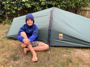 Max Woosey, 10, who has spent 200 nights sleeping in a tent to remember his late neighbours, is seen in this undated handout photo in Braunton, Britain.