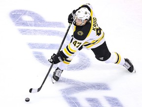Torey Krug of the Boston Bruins attempts a shot against the Carolina Hurricanes during Game 4 of the Eastern Conference first-round series at Scotiabank Arena August 17, 2020 in Toronto.