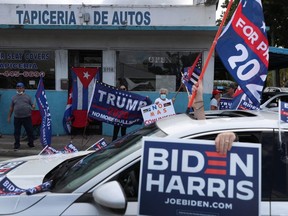 A caravan of supporters for Democratic presidential nominee Joe Biden drive past supporters of President Donald Trump during a Worker Caravan for Biden event in Miami, Sunday, Oct. 18, 2020.