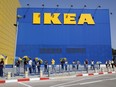 Customers maintain a safe distance from each other as they wait in line to enter an IKEA outlet in the Israeli coastal town of Netanya on April 22, 2020, after authorities eased down some of the measures that have been in place during the novel conronavirus pandemic crisis.