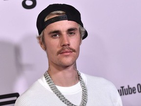 In this file photo Canadian singer Justin Bieber arrives for YouTube Originals' "Justin Bieber: Seasons" premiere at the Regency Bruin Theatre in Los Angeles on January 27, 2020.