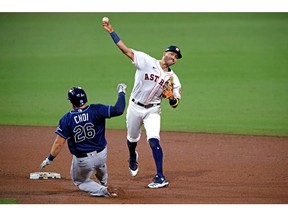 Houston Astros shortstop Carlos Correa (1) can not turn a double play over Tampa Bay Rays first baseman Ji-Man Choi (26) during the ninth inning during game four of the 2020 ALCS at Petco Park.