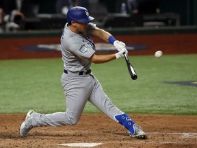 Los Angeles Dodgers catcher Austin Barnes hits a home run against the Tampa Bay Rays during Game 3 of the 2020 World Series at Globe Life Field in Arlington, Texas, on Oct. 23, 2020.