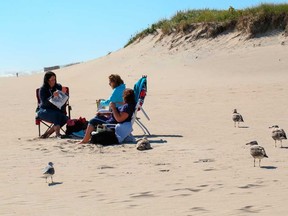 People enjoy the weather on Cooper beach, Sept. 30, 2020 in Southampton, N.Y.