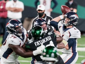 Denver Broncos quarterback Brett Rypien (4) throws the ball as New York Jets defensive tackle Foley Fatukasi (94) defends during the second half at MetLife Stadium Oct. 1, 2020.