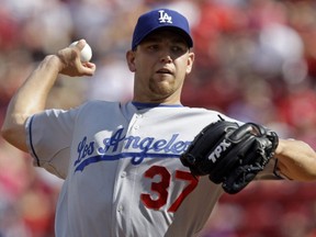In this Aug. 29, 2009, file photo, Dodgers pitcher Charlie Haeger throws a pitch to a Reds batter during a game in Cincinnati.
