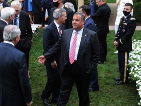 Former New Jersey Governor Chris Christie, centre, talks with guests in the Rose Garden after President Donald Trump introduced 7th U.S. Circuit Court Judge Amy Coney Barrett, 48, as his nominee to the Supreme Court at the White House Sept. 26, 2020 in Washington, D.C.