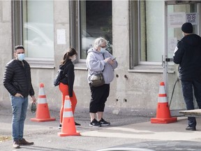 People wait to be tested for COVID-19 at a testing clinic in Montreal, Sunday, Oct. 18, 2020.