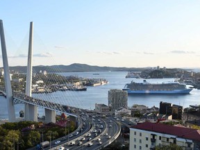 A view shows a bridge over the Golden Horn bay and the Quantum of the Seas cruise ship at a port of Vladivostok, Russia, Sept. 18, 2019.