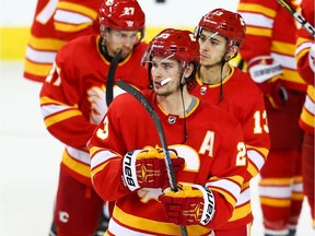 Calgary Flames Austin Czarnik, Sean Monahan and Johnny Gaudreau after losing game five of the Western Conference First Round during the 2019 NHL Stanley Cup Playoffs at the Scotiabank Saddledome in Calgary on Friday, April 19, 2019. Al Charest/Postmedia