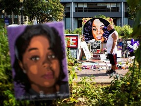 A man pauses at the memorial of Breonna Taylor before a march, after a grand jury decided not to bring homicide charges against police officers involved in the fatal shooting of Taylor in her apartment, in Louisville, Kentucky, U.S. September 25, 2020.