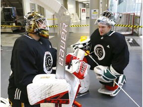 Calgary Flames goalies, L-R, Tyler Parsons and Dustin Wolf get ready to hit the ice during the Flames annual development camp at WinSport Canada in Calgary on Saturday, July 6, 2019. Darren Makowichuk/Postmedia