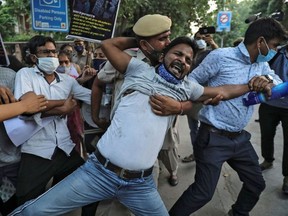 Demonstrators are detained by police during a protest after the death of a rape victim, at Delhi University, in New Delhi, India, October 1, 2020.  b