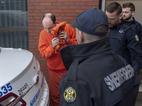 Matthew Raymond is taken from Court of Queen's Bench in Fredericton on Friday, March 13, 2020.