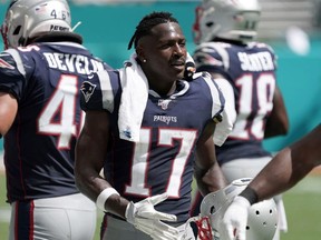 New England Patriots wide receiver Antonio Brown watches from the sidelines in the second half against the Miami Dolphins  at Hard Rock Stadium.