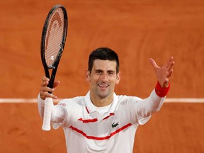 Serbia's Novak Djokovic celebrates after winning his third round match against Colombia's Daniel Elahi Galan Riveros at the French Open in Roland Garros, Paris, Oct. 3, 2020.
