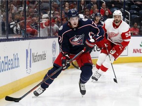 Columbus Blue Jackets forward Josh Anderson, left, controls the puck in front of Detroit Red Wings defenseman Jonathan Ericsson, of Sweden, during the second period of an NHL hockey game in Columbus, Ohio, Thursday, Nov. 21, 2019.
