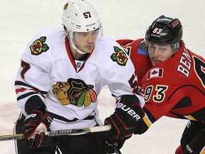 Chicago Blackhawks Trevor van Riemsdyk battles against Sam Bennett of the Calgary Flames during NHL hockey in Calgary, Alta. on Friday November 20, 2015.