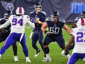 Tennessee Titans quarterback Ryan Tannehill, middle, drops back to pass during the first half against the Buffalo Bills at Nissan Stadium in Nashville, Tennessee, Oct. 13, 2020.