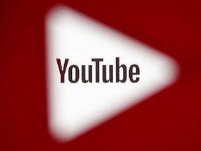 A 3D-printed YouTube icon is seen in front of a displayed YouTube logo in this illustration taken October 25, 2017.
