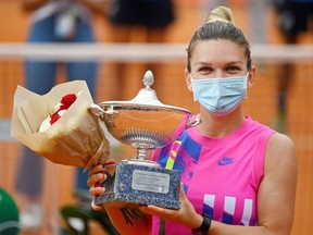 Tennis - WTA Premier 5 - Italian Open - Foro Italico, Rome, Italy - September 21, 2020  Romania's Simona Halep as she celebrates winning the final with the trophy after Czech Republic's Karolina Pliskova retired from the match after sustaining an injury .